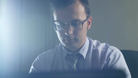 business-man-sitting-in-front-of-laptop-at-night