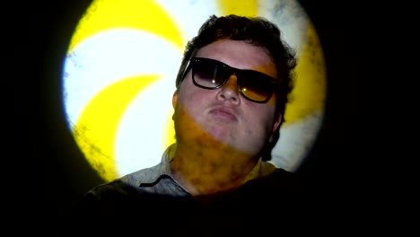 Portrait-of-a-fat-man-in-a-multicolored-light-beam.