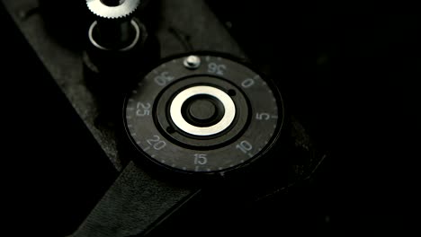 Old-camera-closeup-in-slow-motion.-Pressing-film-rewind-button