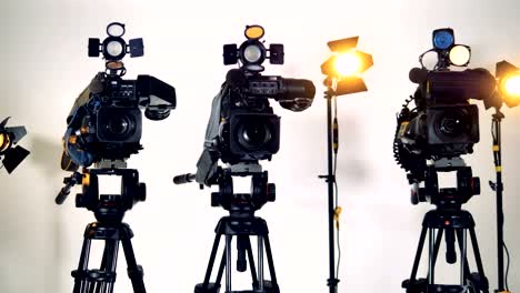 Three-professional-video-cameras-on-tripods.