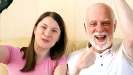 Father-and-daughter-gamers-playing-video-game-at-home.Players-with-remote-controller-of-game-console