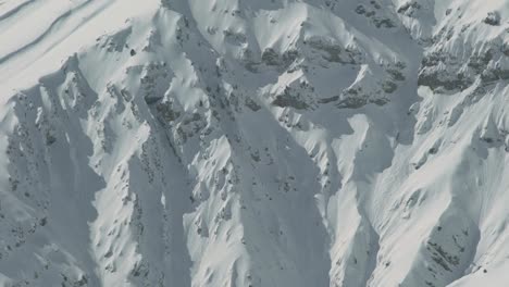 Heliskiing-Helicopter-flies-against-the-background-of-the-snow-capped-mountains