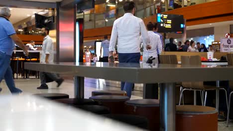 Busy-big-waiting-hall-of-terminal-with-passengers-going-for-the-flight.-People-walking-in-airport.-Time-lapse