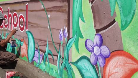 Mural-painter-draws-garden-on-the-school-wall