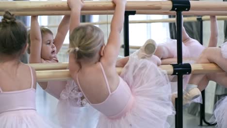 Four-Girls-Standing-at-Ballet-Barre