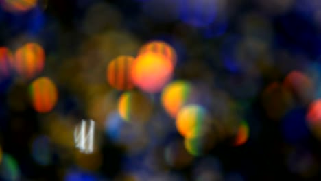 Defocused-shimmering-multicolored-glitter-confetti,-black-background.-Holiday-abstract-festive-bokeh-light-spots.