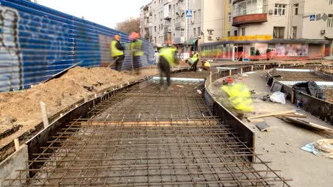 Workers-with-protective-mask-welding-reinforcement-for-tram-tracks-in-the-city-timelapse