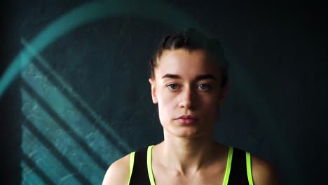 Slow-motion-young-serious-female-boxer-in-wrapped-hands-warming-up,-jumping-on-skipping-rope-closeup