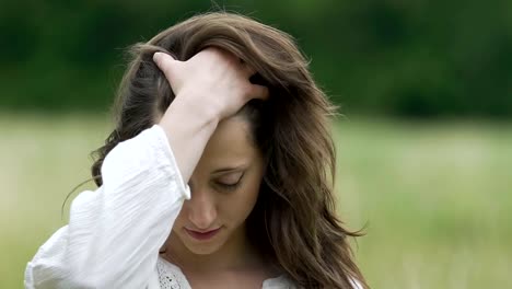 Schöne-Frau-Kämme-Haar-mit-Hand-selbst-im-Freien-genießt-Zeitlupe