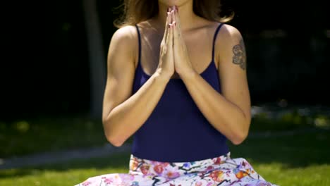 Meditating-yogi-female-folds-hands-in-namaste-to-express-gratitude-to-Universe