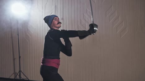 Medieval-warrior-training-with-sword-indoors-in-slow-motion.-Medium-shot
