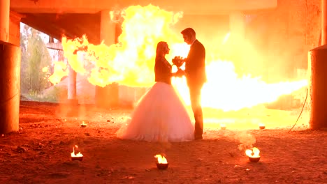 Couple-with-makeup-for-Halloween,-in-the-background-huge-flame-of-of-fire-show.