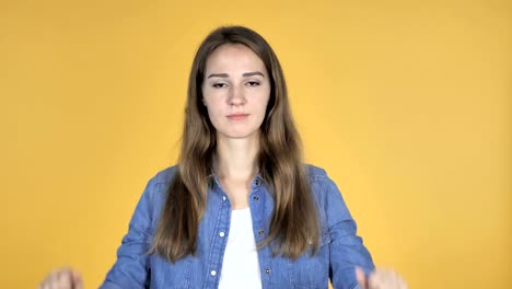 Pretty-Woman-Gesturing-Thumbs-Down-Isolated-on-Yellow-Background