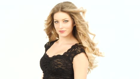 blonde-woman-with-long-wavy-hair-movd-by-the-wind-wearing-a-black-lace-shirt
