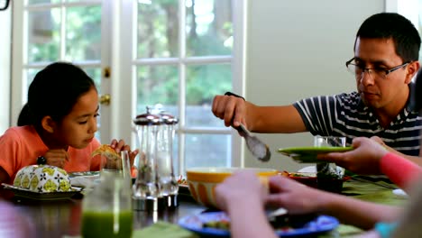 Family-members-having-breakfast-on-dining-table-4k