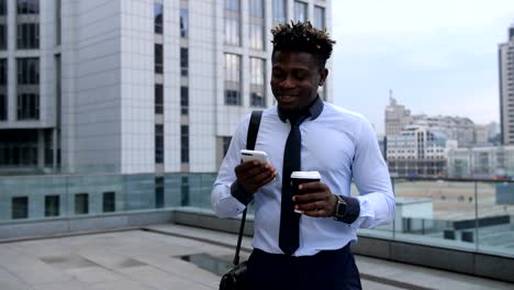 Businessman-drinking-coffee-and-checking-phone