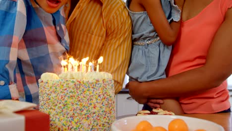 Mid-section-of-black-family-celebrating-birthday-in-kitchen-of-comfortable-home-4k