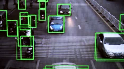 CCTV-camera.-Real-time-tracking-of-vehicles-and-people-on-the-street.-Authentic-pixelated-image-from-a-real-monitor.