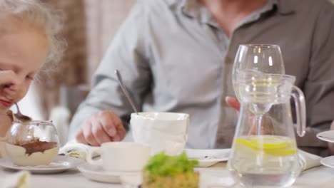 Little-Girl-and-Parents-Eating-in-Restaurant