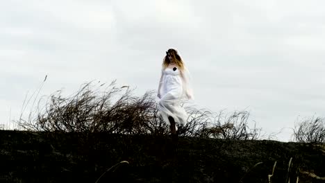 Halloween-makeup.-The-young-woman-in-a-bride-dress-on-the-background-of-sky.-4K