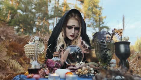 Halloween.-Young-Witch-Spells-At-The-Table.