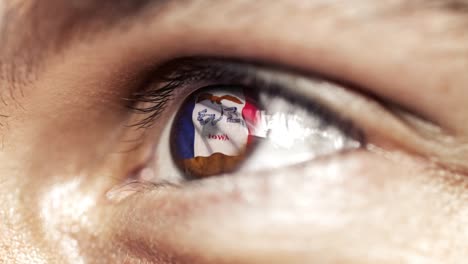 Man-with-brown-eye-in-close-up,-the-flag-of-Iowa-state-in-iris,-united-states-of-america-with-wind-motion.-video-concept