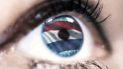 woman-blue-eye-in-close-up-with-the-flag-of-netherlands-in-iris-with-wind-motion.-video-concept