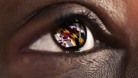 Woman-black-eye-in-close-up-with-the-flag-of-Maryland-state-in-iris,-united-states-of-america-with-wind-motion.-video-concept