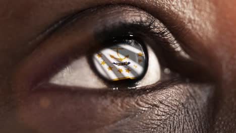 Woman-black-eye-in-close-up-with-the-flag-of-Rhode-Island-state-in-iris,-united-states-of-america-with-wind-motion.-video-concept