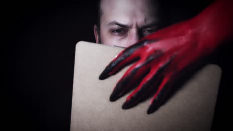 4k-Horror-Devil's-Hand-Giving-Businessman-Contract-to-Sign