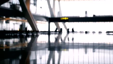 Defocused-airport-baackground.-Silhouette-people-walking-at-the-airport.