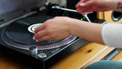 woman-turns-off-the-turntable-takes-the-LP