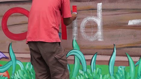 Mural-painter-draws-letter-i-on-school-wall.-time-lapse