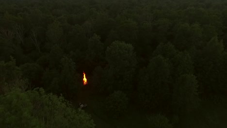 Aerial-view-of-a-campfire-in-the-forest-at-sunset-in-Estonia.