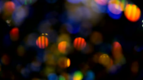 Defocused-shimmering-multicolored-glitter-confetti,-black-background.-Holiday-abstract-festive-bokeh-light-spots.