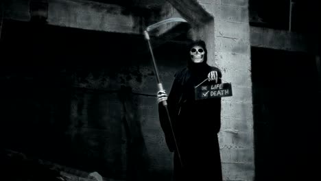 death-with-a-scythe-raises-a-sign-with-the-inscription-life-or-death