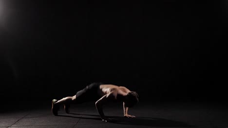 Young-muscular-fitness-model-doing-burpees-in-the-fitness-studio