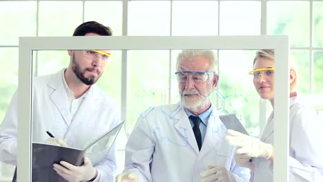 Science-teacher-and-students-team-working-with-chemicals-on-glass-Board-in-lab