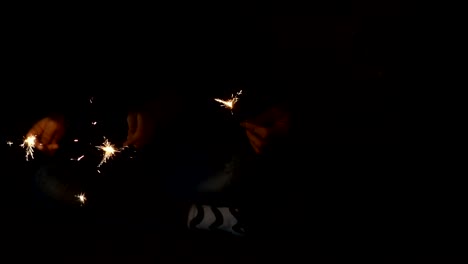 Sparkler-in-hands-mother-and-daughter-on-new-year-party-slow-motion-shot