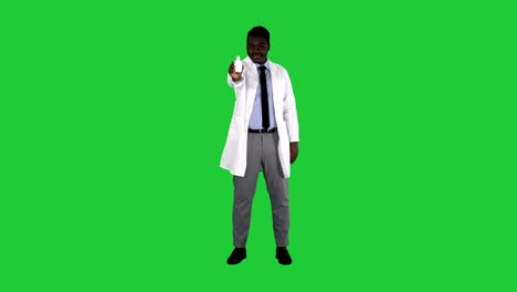 Afro-american-doctor-presenting-nasal-spray-on-a-Green-Screen,-Chroma-Key