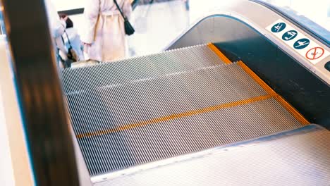 Legs-of-People-Moving-on-an-Escalator-Lift-in-Shopping-Center