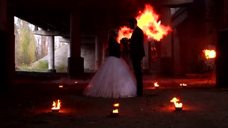 Couple-with-makeup-for-Halloween-at-a-party,-a-huge-fire-is-burning-nearby.