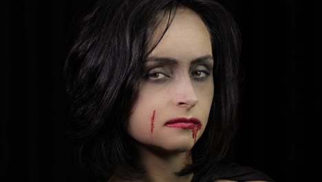 Vampire-Halloween-makeup.-Woman-portrait-with-blood-on-her-face.