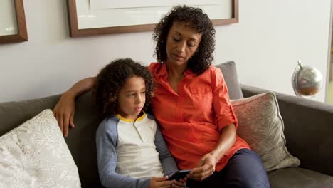 Front-view-of-African-american-mother-talking-with-her-son-in-the-lobby-at-hospital-4k