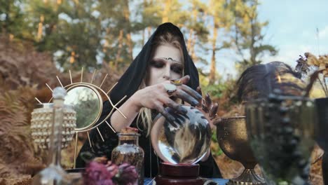 Halloween.-Young-Witch-Spells-At-The-Table.