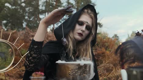 Halloween.-Young-Witch-Spells-At-The-Table.