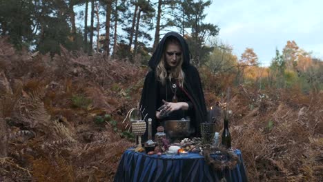 Halloween.-Young-Witch-Spells-At-The-Table.