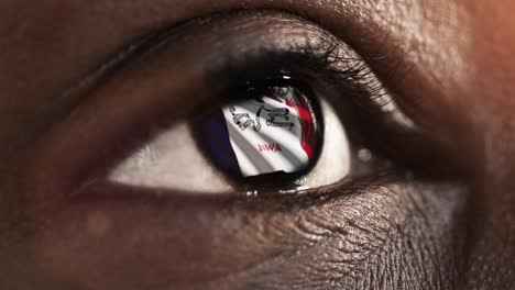 Woman-black-eye-in-close-up-with-the-flag-of-Iowa-state-in-iris,-united-states-of-america-with-wind-motion.-video-concept