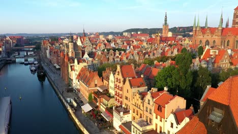 Gdansk-old-city-in-the-rays-of-the-rising-sun,-aerial-view-of-the-old-city-streets