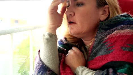 Sad-young-woman-looking-through-window